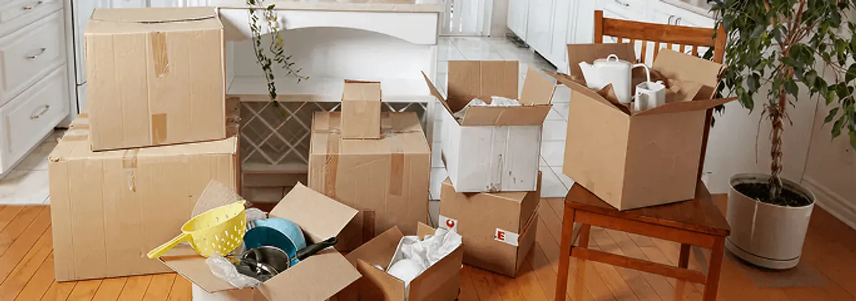 Packed moving boxes and household items in a kitchen before move-out or move-in cleaning, Gilbert, AZ.